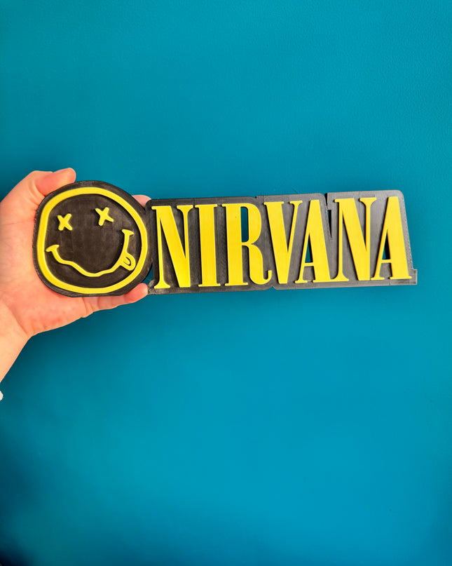 Plaque murale Nirvana en 3D, noir et jaune, format 24 cm.

